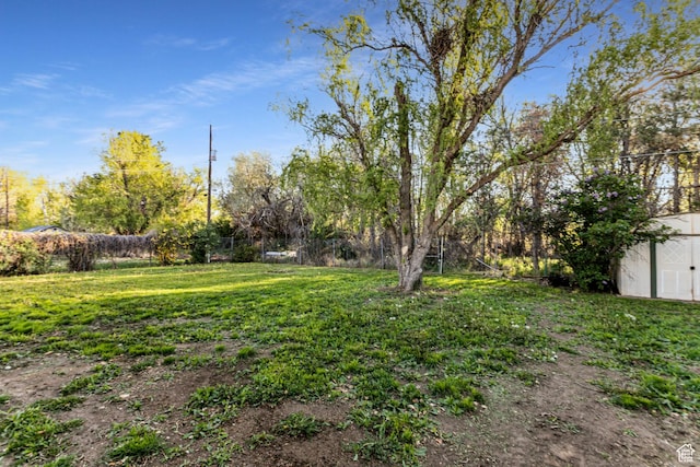 5952 S 2550 W, Roy, UT 84067 - view of yard with an outdoor structure, a fenced backyard, and a storage shed