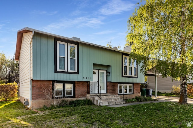 5952 S 2550 W, Roy, UT 84067 - raised ranch featuring brick siding and a front lawn