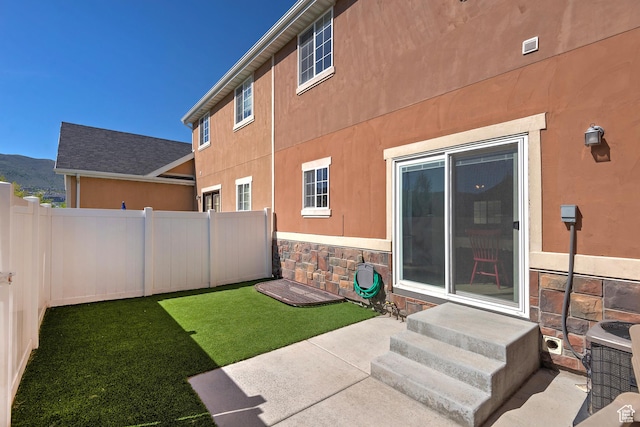view of yard featuring fence, entry steps, and a patio area