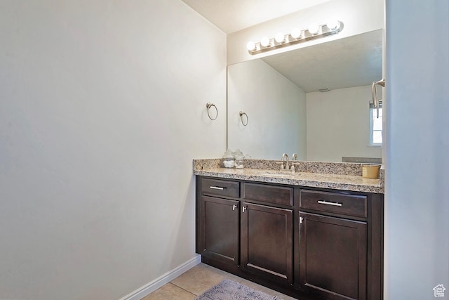 bathroom with tile patterned flooring, baseboards, and vanity