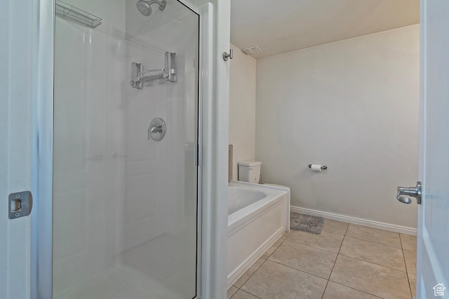 bathroom featuring baseboards, tile patterned flooring, a shower stall, and a bath