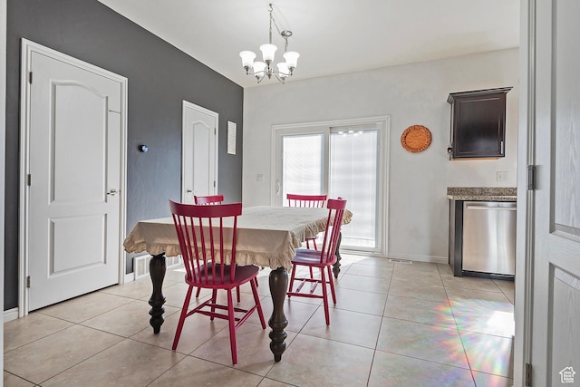 dining area with baseboards, light tile patterned floors, and a notable chandelier