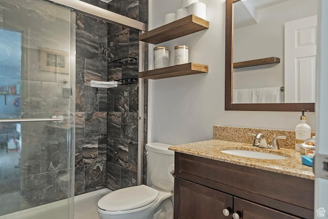 full bath with vanity, a stall shower, and toilet