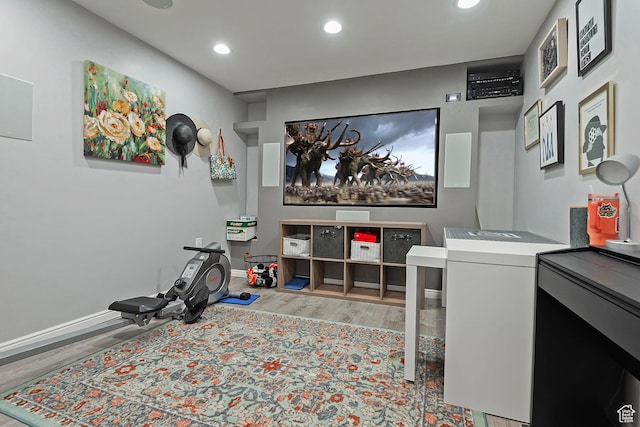 interior space with baseboards, recessed lighting, and wood finished floors