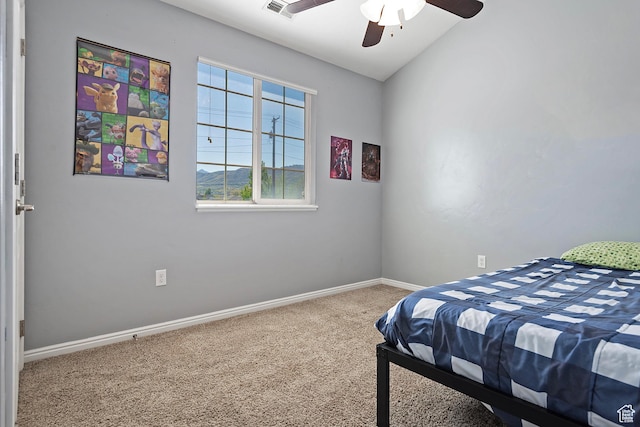 carpeted bedroom featuring baseboards, ceiling fan, and visible vents