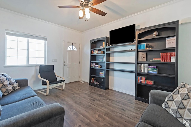 living room with baseboards, ceiling fan, ornamental molding, and wood finished floors
