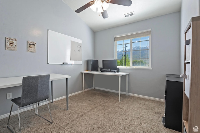 carpeted home office featuring visible vents, baseboards, ceiling fan, and vaulted ceiling