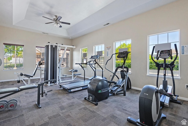 workout area featuring baseboards, ceiling fan, visible vents, and a healthy amount of sunlight
