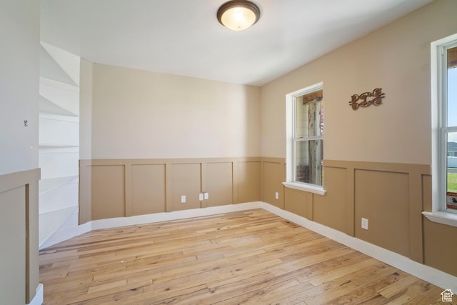 220 N 810 E, Smithfield, UT 84335 - empty room with plenty of natural light, a wainscoted wall, and hardwood / wood-style floors