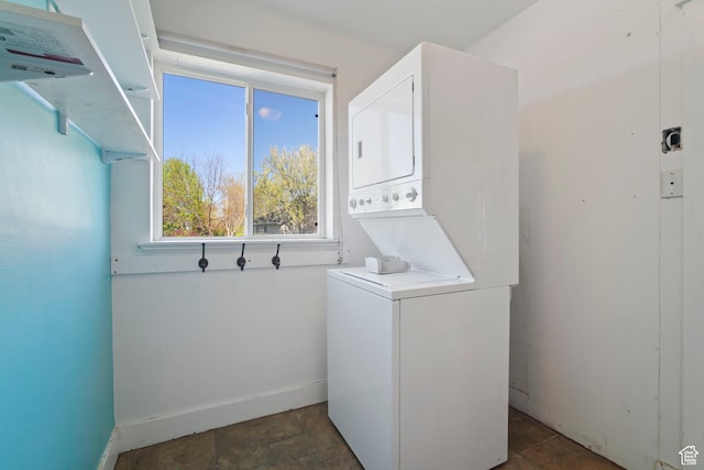 220 N 810 E, Smithfield, UT 84335 - washroom with baseboards, laundry area, stone finish floor, and stacked washer / dryer