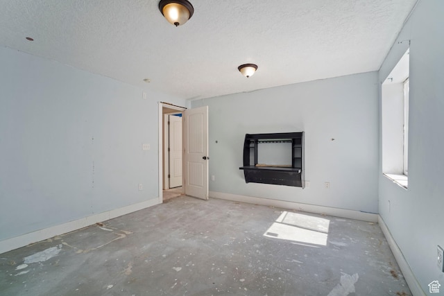 220 N 810 E, Smithfield, UT 84335 - unfurnished living room featuring baseboards and a textured ceiling
