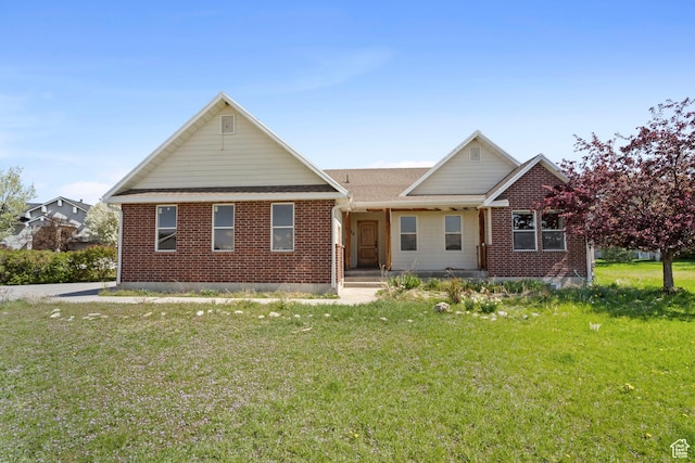 ranch-style house featuring brick siding and a front lawn