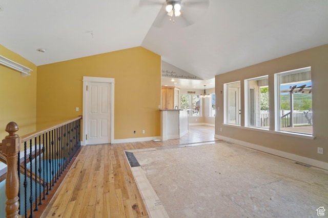 220 N 810 E, Smithfield, UT 84335 - interior space featuring visible vents, baseboards, light wood-style floors, ceiling fan with notable chandelier, and vaulted ceiling