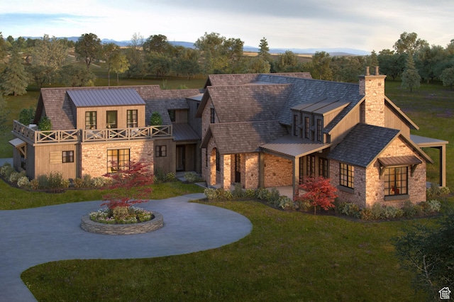 view of front of home featuring a standing seam roof, metal roof, a chimney, a front yard, and stone siding