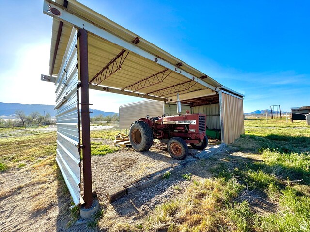 848 N Cooley St W, Grantsville, UT 84029 - view of vehicle parking featuring a carport, a pole building, and a mountain view