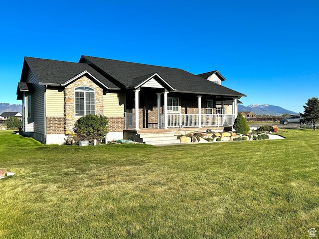 848 N Cooley St W, Grantsville, UT 84029 - ranch-style home with a mountain view, a porch, brick siding, and a front yard