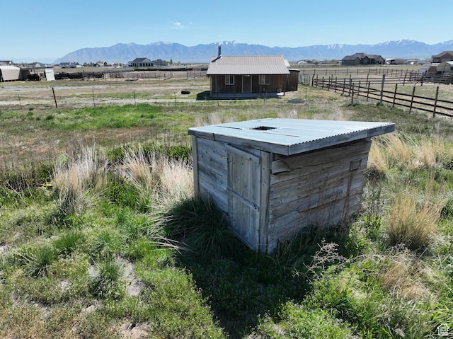 848 N Cooley St W, Grantsville, UT 84029 - view of outbuilding featuring an outdoor structure, a rural view, fence, and a mountain view