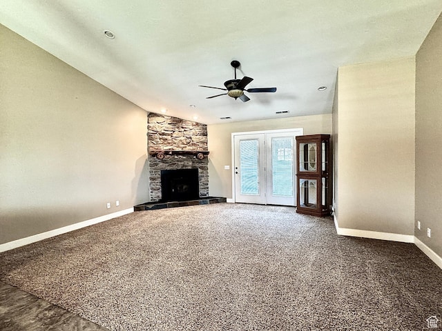 848 N Cooley St W, Grantsville, UT 84029 - unfurnished living room with a stone fireplace, a ceiling fan, baseboards, and carpet flooring