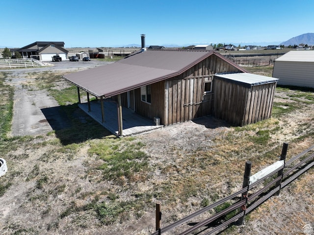 848 N Cooley St W, Grantsville, UT 84029 - back of house featuring fence, metal roof, and a carport