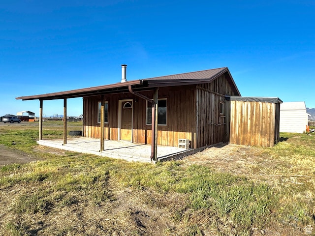 848 N Cooley St W, Grantsville, UT 84029 - back of house with board and batten siding and a patio area