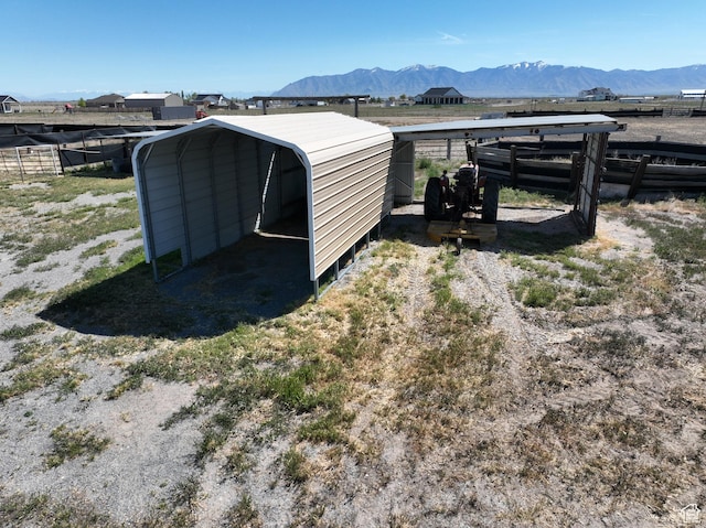 848 N Cooley St W, Grantsville, UT 84029 - view of outbuilding with fence, a mountain view, and a detached carport