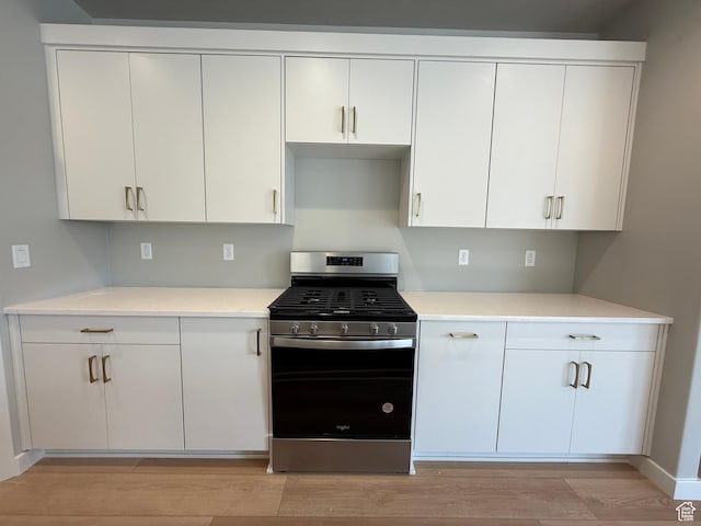 20 N 3830 W Unit 445, West Point, UT 84015 - kitchen with stainless steel gas stove, light wood-type flooring, light countertops, and white cabinetry