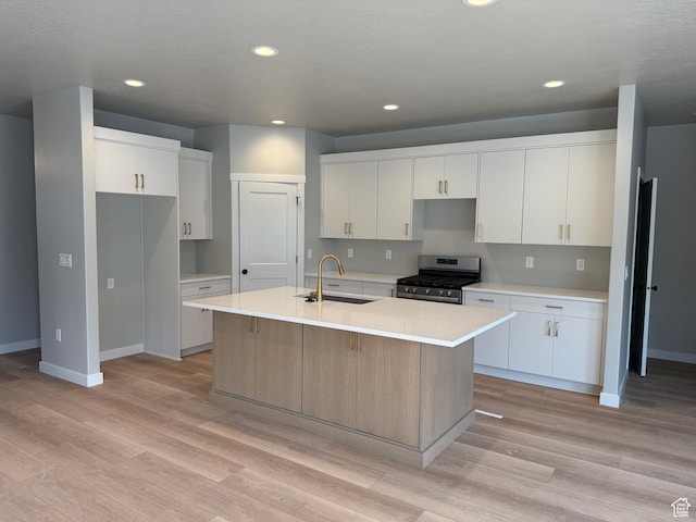 20 N 3830 W Unit 445, West Point, UT 84015 - kitchen featuring a sink, gas stove, light wood-style flooring, an island with sink, and recessed lighting