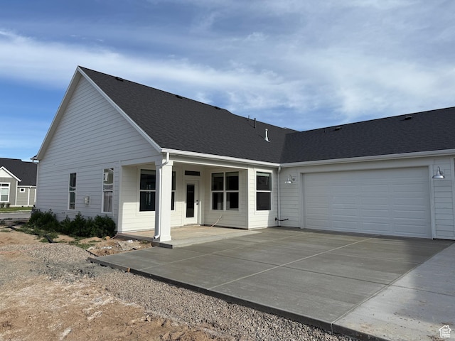 20 N 3830 W Unit 445, West Point, UT 84015 - view of front of property with driveway, a garage, and a shingled roof