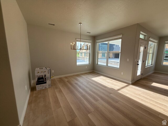 20 N 3830 W Unit 445, West Point, UT 84015 - unfurnished dining area with a chandelier, wood finished floors, baseboards, a textured ceiling, and heating unit