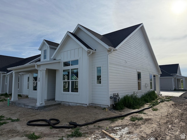 20 N 3830 W Unit 445, West Point, UT 84015 - view of home's exterior featuring a porch and board and batten siding