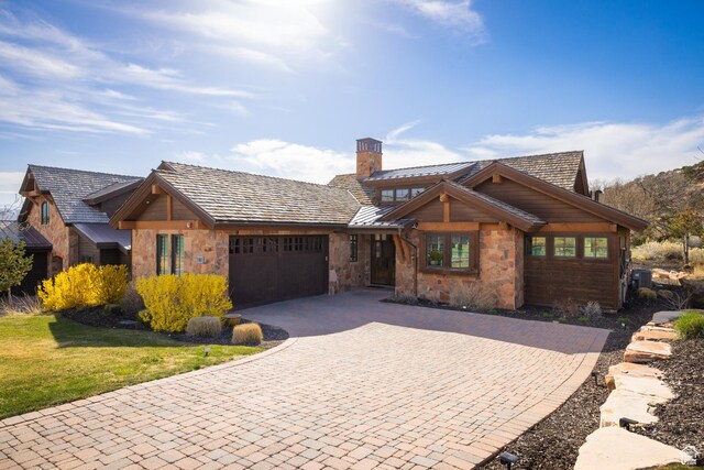 181 N Club Cabins Ct, Heber City, UT 84032 - view of front of property with a garage, stone siding, decorative driveway, a chimney, and a standing seam roof