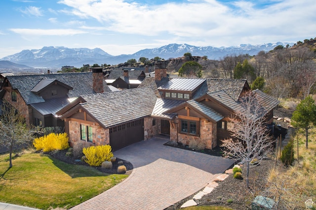 181 N Club Cabins Ct, Heber City, UT 84032 - view of front facade with a garage, stone siding, decorative driveway, a standing seam roof, and a mountain view