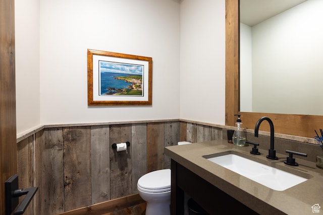 181 N Club Cabins Ct, Heber City, UT 84032 - bathroom featuring wooden walls, vanity, toilet, a wainscoted wall, and wood finished floors