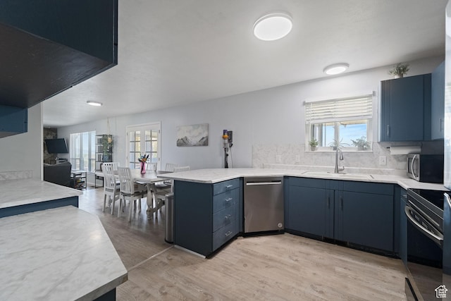 9968 S Blossom Dr, Sandy, UT 84092 - kitchen featuring appliances with stainless steel finishes, a sink, a peninsula, and plenty of natural light