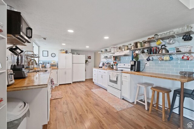 9968 S Blossom Dr, Sandy, UT 84092 - kitchen with white appliances, wood counters, open shelves, a sink, and light wood-style floors