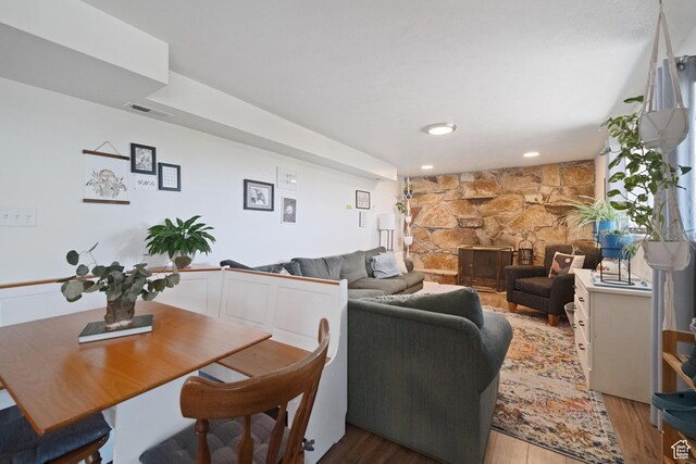 9968 S Blossom Dr, Sandy, UT 84092 - dining room with a stone fireplace and light wood-type flooring