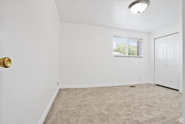 218 E Julie Anna Dr, Sandy, UT 84070 - unfurnished bedroom with a closet, baseboards, carpet flooring, and visible vents
