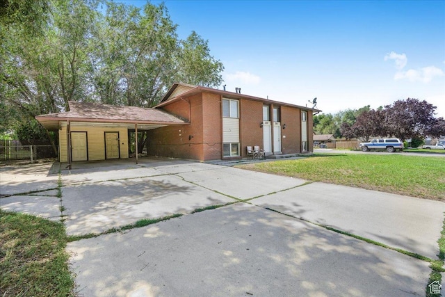 218 E Julie Anna Dr, Sandy, UT 84070 - view of front of home with driveway, a front yard, a carport, brick siding, and fence