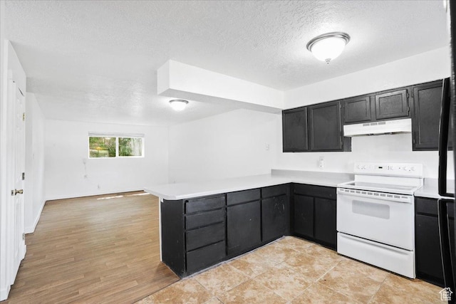 218 E Julie Anna Dr, Sandy, UT 84070 - kitchen with electric range, a peninsula, light countertops, under cabinet range hood, and dark cabinets