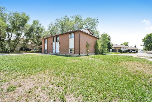 218 E Julie Anna Dr, Sandy, UT 84070 - view of side of home featuring a yard and brick siding