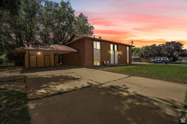218 E Julie Anna Dr, Sandy, UT 84070 - exterior space featuring fence, brick siding, concrete driveway, a lawn, and a carport