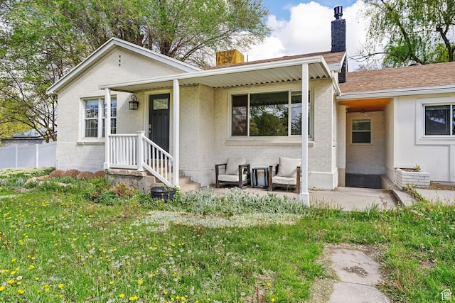 605 E 700 N, Pleasant Grove, UT 84062 - view of front facade featuring brick siding, a front yard, and a chimney