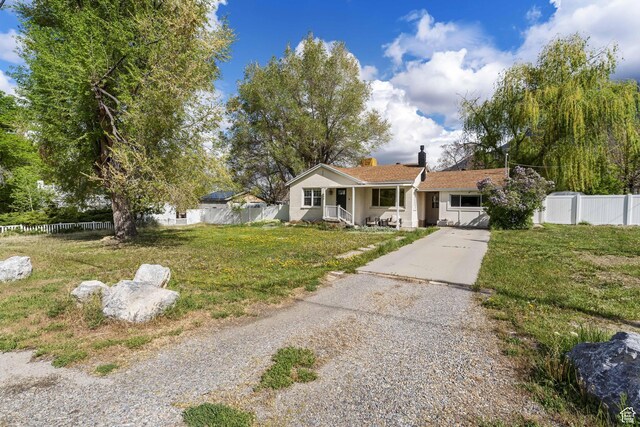 605 E 700 N, Pleasant Grove, UT 84062 - view of front of house with a porch, fence, a chimney, and concrete driveway