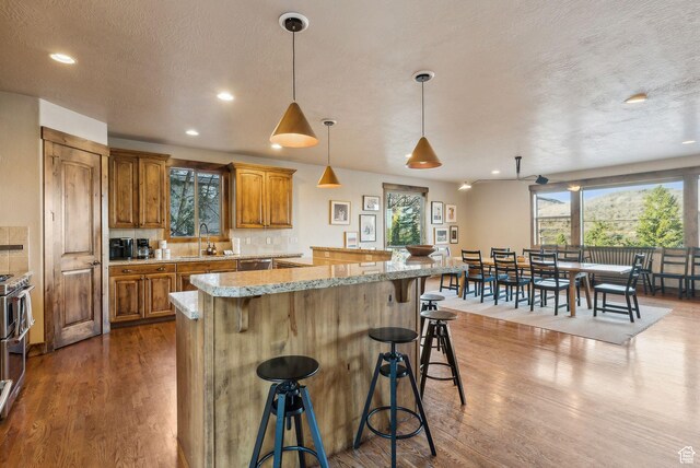 210 Parkview Dr, Summit Park, UT 84098 - kitchen featuring a kitchen breakfast bar, brown cabinets, and wood finished floors