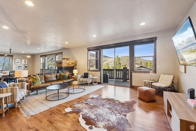 210 Parkview Dr, Summit Park, UT 84098 - living area featuring recessed lighting, wood finished floors, and a lit fireplace