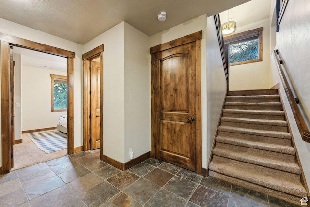 210 Parkview Dr, Summit Park, UT 84098 - stairs featuring a healthy amount of sunlight, baseboards, and stone tile floors