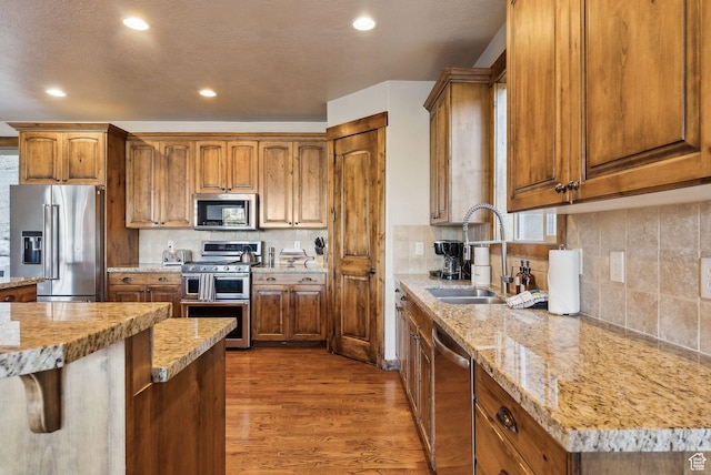 210 Parkview Dr, Summit Park, UT 84098 - kitchen featuring appliances with stainless steel finishes, brown cabinetry, a sink, and dark wood-type flooring
