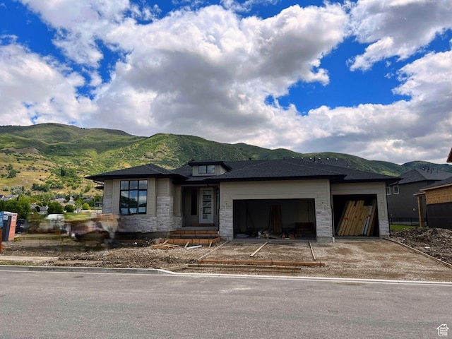 581 W Summerhill Ln N, Centerville, UT 84014 - prairie-style house featuring a mountain view, a garage, stone siding, and driveway