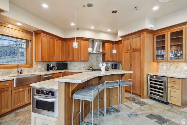 1386 Pinnacle Dr Unit 82, Park City, UT 84060 - kitchen featuring beverage cooler, wall chimney range hood, brown cabinets, stainless steel appliances, and recessed lighting