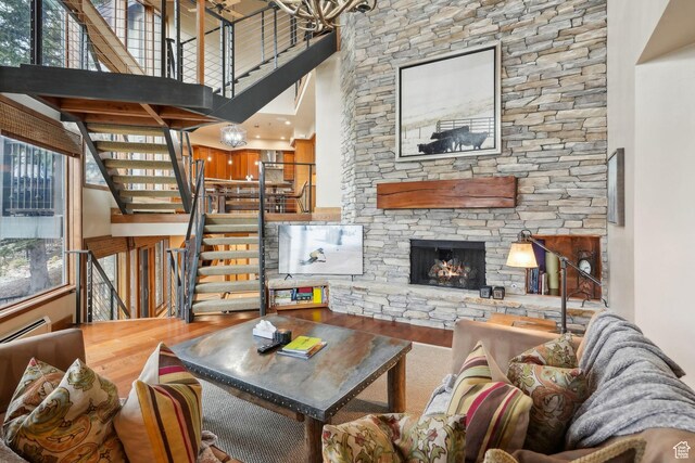 1386 Pinnacle Dr Unit 82, Park City, UT 84060 - living room featuring a towering ceiling, stairs, wood finished floors, and a stone fireplace
